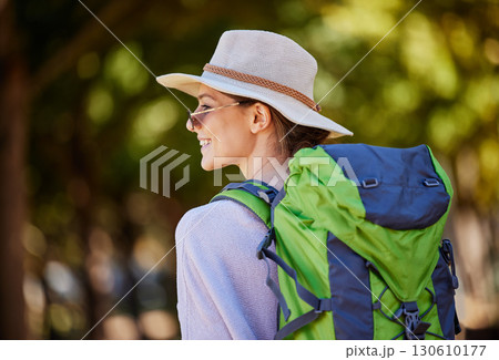 Woman, backpack or sightseeing in nature travel, park adventure or trees forest in Canada woods. Smile, happy or tourist with hiking hat, bag or fitness gear in countryside location for camping trip 130610177
