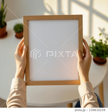Empty picture frame in hands. Stylish wooden photoframe Empty picture frame in hands. Stylish wooden photoframe 130610239