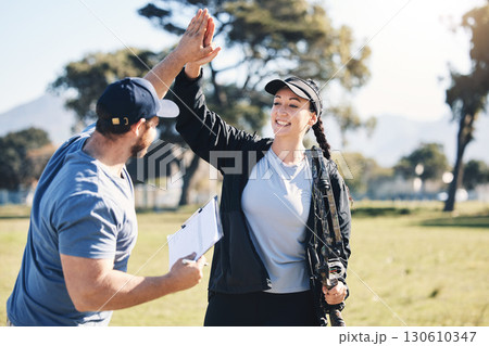 Woman, archery and personal trainer high five in sports for partnership, success or celebration on the grass field. Happy sporty female smile and touching hand of male coach for archer sport training Woman, archery and personal trainer high five in sports for partnership, success or celebration on the grass field. Happy sporty female smile and touching hand of male coach for archer sport training 130610347
