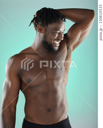 Armpit, bicep and happy man with skincare hygiene or grooming isolated against a studio background. Natural, cosmetics and body care for healthy skin by a young, confident and African model Armpit, bicep and happy man with skincare hygiene or grooming isolated against a studio background. Natural, cosmetics and body care for healthy skin by a young, confident and African model 130610535