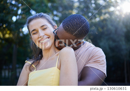 Love, park and kissing with an interracial couple bonding outdoor together on a romantic date in nature. Summer, romance and diversity with a man and woman dating outside in a green garden 130610631