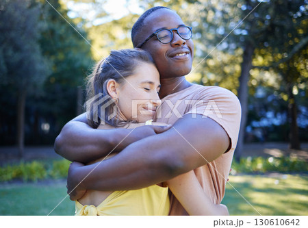 Black man, interracial couple and hug on park lawn with love, care and bonding for quality time, reunion and happiness. Multicultural embrace, happy relationship and outdoor diversity on adventure Black man, interracial couple and hug on park lawn with love, care and bonding for quality time, reunion and happiness. Multicultural embrace, happy relationship and outdoor diversity on adventure 130610642