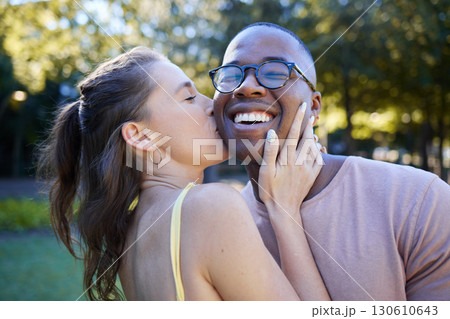 Woman kiss man, happiness and date in park, outdoor in nature with love and commitment in interracial relationship. Trust, support and happy couple, content with smile on face and fresh air Woman kiss man, happiness and date in park, outdoor in nature with love and commitment in interracial relationship. Trust, support and happy couple, content with smile on face and fresh air 130610643