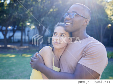 Interracial couple, hug and park with smile, thinking or love for bonding, together and vision of future. Multicultural relationship, black man and woman for happiness, outdoor and diversity on grass Interracial couple, hug and park with smile, thinking or love for bonding, together and vision of future. Multicultural relationship, black man and woman for happiness, outdoor and diversity on grass 130610644