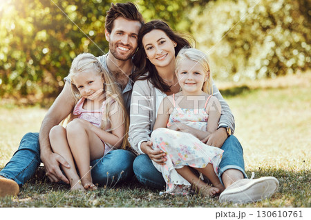 Family, garden and portrait of parents, children and happy people on park grass in sunshine. Kids, mom and dad smile with love in nature, holiday and summer vacation to relax on park lawn with peace 130610761