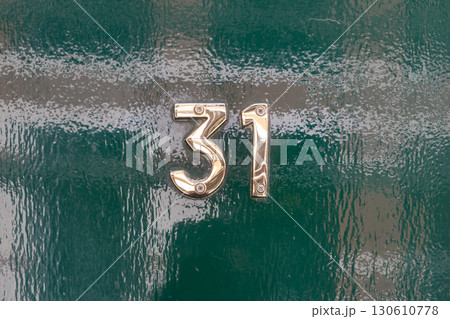 Brass number thirty one on glossy green door Brass number thirty one on glossy green door 130610778