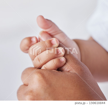 Closeup, hands and mother with baby, love and support for care, health and wellness on studio background. Zoom, hand and mama with infant, protection and child development with bonding and maternity Closeup, hands and mother with baby, love and support for care, health and wellness on studio background. Zoom, hand and mama with infant, protection and child development with bonding and maternity 130610844