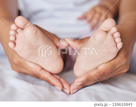 Closeup, feet and baby with mother, hands and care for kid, support and touch for bonding and playful. Zoom, mama and infant with health, wellness and newborn with female parent or child development Closeup, feet and baby with mother, hands and care for kid, support and touch for bonding and playful. Zoom, mama and infant with health, wellness and newborn with female parent or child development 130610845