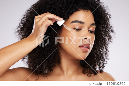 Cosmetics, black woman and skincare with pipette, oil and girl with beauty against grey studio background. African American female, lady and liquid serum for dermatology, collagen and organic facial Cosmetics, black woman and skincare with pipette, oil and girl with beauty against grey studio background. African American female, lady and liquid serum for dermatology, collagen and organic facial 130610862