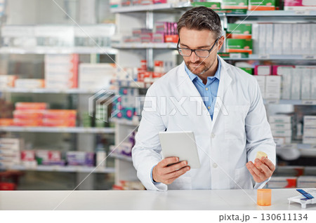 Pharmacist man, shop and reading with tablet, medicine, pills and counter for health, medication or sales. Medical professional, pharma expert and mobile digital tech in pharmacy with wellness app 130611134