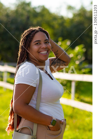 Smiling plus size woman standing park in stylish outfit Smiling plus size woman standing park in stylish outfit 130611203