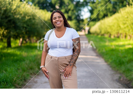 African American plus size woman smiling while walking outdoors African American plus size woman smiling while walking outdoors 130611214