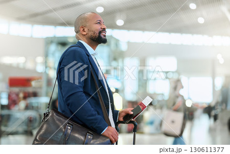 African businessman, airport terminal and walking, search or thinking for flight schedule time with passport. Corporate black man, global travel and focus on itinerary with personal luggage in London African businessman, airport terminal and walking, search or thinking for flight schedule time with passport. Corporate black man, global travel and focus on itinerary with personal luggage in London 130611377