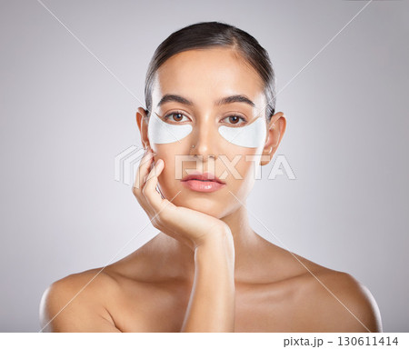 Beauty, eye patch and portrait of woman with skincare product for self care, anti aging and wellness. Facial healthcare, spa salon and aesthetic model face with makeup cosmetics on studio background 130611414