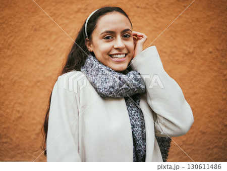 Happy woman, portrait or hair tuck behind ear by city wall, mockup background or brown mock up in Portugal. Smile, fashion or model in trendy, cool or warm style clothes on building copyspace brand 130611486