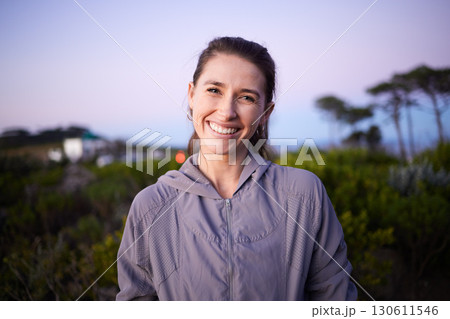 Happy, sunset and portrait of a woman in a park during dusk for peace, calm and zen. Adventure, hike and face of a girl on a walk for fitness, summer cardio and relaxing during dawn in nature 130611546