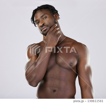 Thinking, portrait and black man in studio for wellness, grooming and hygiene on grey background. Muscular, man and beauty routine on mockup, relax and skincare treatment on shirtless model isolated 130611581