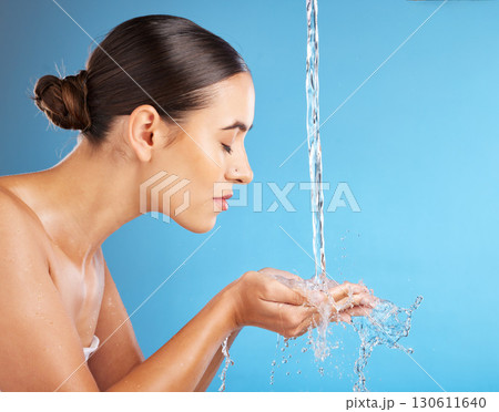 Woman, hands and water for skincare hydration, hygiene or face wash against a blue background. Beautiful female in facial cleaning, washing or cleansing for skin rehydration or dermatology on mockup Woman, hands and water for skincare hydration, hygiene or face wash against a blue background. Beautiful female in facial cleaning, washing or cleansing for skin rehydration or dermatology on mockup 130611640