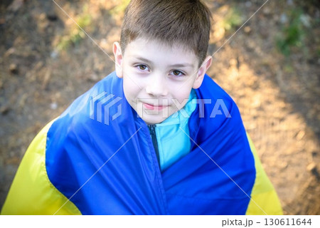 Pray for Ukraine. boy with Ukrainian flag running the summer par 130611644