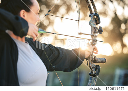 Woman, bow or arrows aim in sports field, shooting range or gaming ground for hunting, hobby or performance exercise. Archery, person or athlete and weapon in target training, competition or practice 130611673