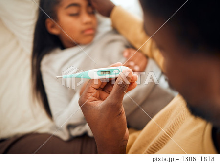 Child, girl and dad checking thermometer for ill kid or daughter lying on a bed feeling sad. Support, care and parent in bedroom to help a worried child in pain with flu, cold or fever 130611818