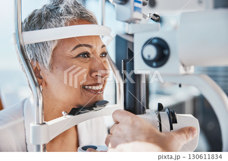 Face, eye exam or happy woman in test or consulting doctor for eyesight assessment at optometrist office. Senior customer testing vision with optician helping or checking iris or retina visual health 130611834