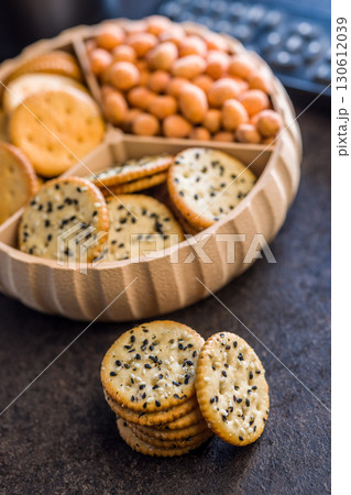 Crispy round salted crackers on black table. Crispy round salted crackers on black table. 130612039