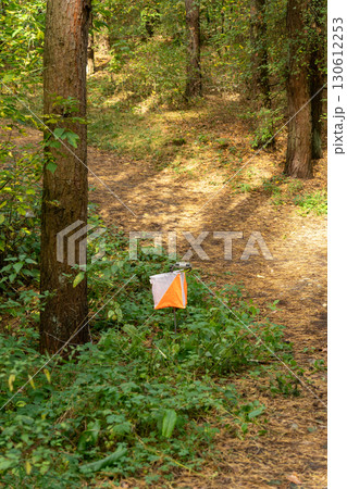 Orienteering. Control point Prism and electric composter for orienteering in the autumn forest. Orienteering. Control point Prism and electric composter for orienteering in the autumn forest. 130612253