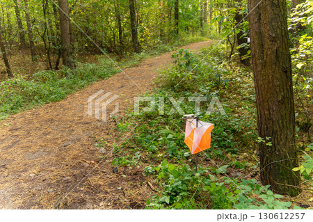 Orienteering. Control point Prism and electric composter for orienteering in the autumn forest. Orienteering. Control point Prism and electric composter for orienteering in the autumn forest. 130612257