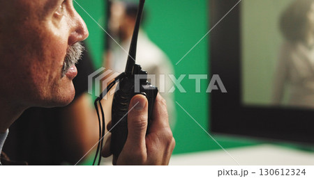Man, film director or radio with green screen for action, scene or instruction in production studio. Male person, producer or manager talking with signal cut for take, cue or special effects in set 130612324