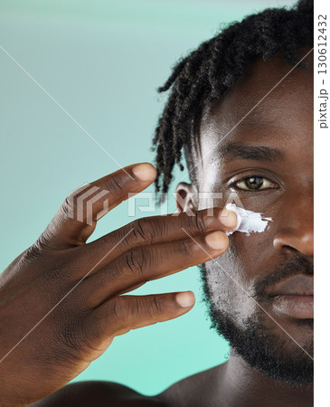Black man, hands and face for skincare moisturizer, lotion or cream for facial glow or treatment against studio background. African American male, person or guy applying creme for smooth or soft skin Black man, hands and face for skincare moisturizer, lotion or cream for facial glow or treatment against studio background. African American male, person or guy applying creme for smooth or soft skin 130612432