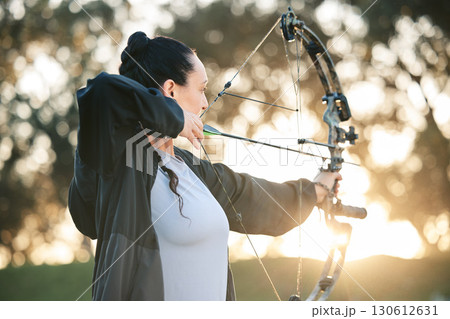 Person, bow or arrows aim in sports field, shooting range or gaming ground for hunting, hobby or performance exercise. Archery, woman or athlete and weapon in target training, competition or practice Person, bow or arrows aim in sports field, shooting range or gaming ground for hunting, hobby or performance exercise. Archery, woman or athlete and weapon in target training, competition or practice 130612631