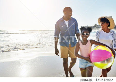 Black family, mockup or beach with a mother, father and daughter carrying a ball while walking on the sand by the sea. Love, children and ocean with a man, woman and girl child on the coast in summer 130612682