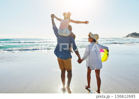 Walking black family, beach and back of people holding hands, parents and child enjoy fun outdoor quality time together. Ocean sea water, freedom peace and youth kid, father and mother in Jamaica 130612695