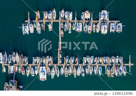 Ocean, harbor and drone of boats on the water for travel, sailing and holiday in Spain. Environment, marine and above of sea transportation at a port for vacation, cruise and traveling adventure Ocean, harbor and drone of boats on the water for travel, sailing and holiday in Spain. Environment, marine and above of sea transportation at a port for vacation, cruise and traveling adventure 130612696