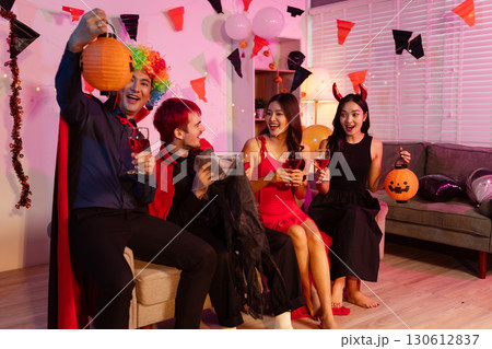 Dinner and group of people celebrating together at Halloween party. 130612837