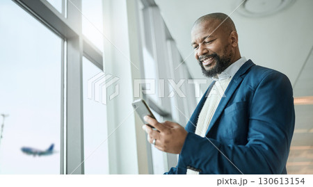 Email, travel and black man with a phone at the airport for connection, communication and work update. Happy, executive and African businessman reading information on a mobile while on a trip Email, travel and black man with a phone at the airport for connection, communication and work update. Happy, executive and African businessman reading information on a mobile while on a trip 130613154