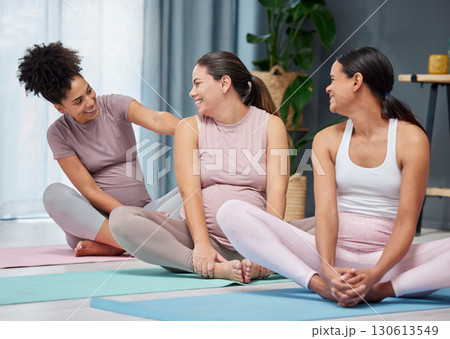 Pregnant yoga, friends and relax on living room floor before exercise, fitness and health, talking and happy. Women, pregnancy and female group sitting together before workout, meditation and cardio 130613549