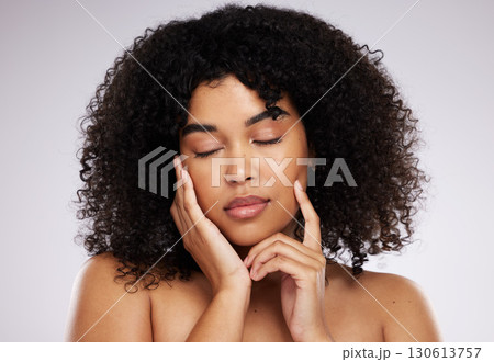 Dermatology, cosmetics and black woman with eyes closed, hand on face and afro, advertising luxury makeup. Skincare, beauty and facial skin care product promo on model isolated on studio background. 130613757