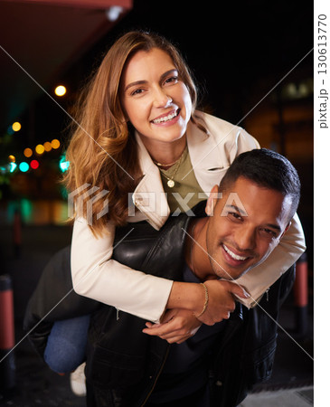 Couple of friends, piggyback and night portrait on city street or road in birthday celebration, romance date and goofy game. Smile, happy and man carrying woman in comic activity and silly bonding 130613770