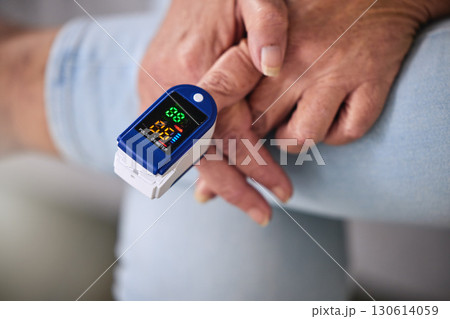 Pulse oximeter, healthcare and woman taking her heart rate in a retirement home during consultation. Medical, treatment and senior female patient measuring her oxygen blood levels with health device. 130614059