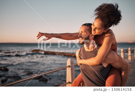 Fitness, couple and piggyback for beach sunset, travel or fun holiday journey together in the outdoors. Happy man and woman enjoying back ride by the ocean coast after running exercise or workout Fitness, couple and piggyback for beach sunset, travel or fun holiday journey together in the outdoors. Happy man and woman enjoying back ride by the ocean coast after running exercise or workout 130614158