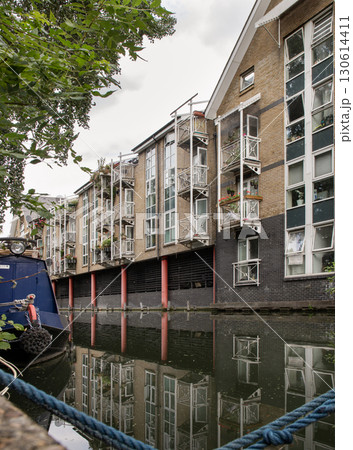 a picturesque scene of residential buildings situated along the banks of the Paddington Branch of the Grand Union Canal in London. 130614411