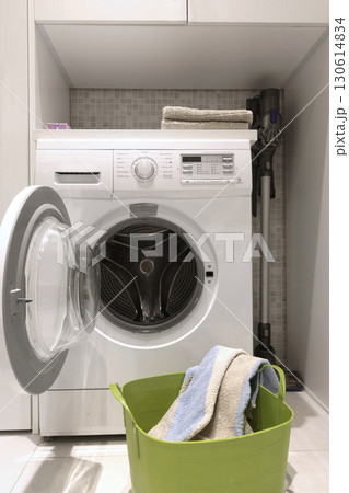 Laundry room in house. Washing machine and linen storage cabinet. Cleanliness and lifestyle. Activities, house cleaning. 130614834