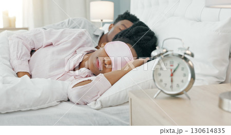 Sleeping, love and couple with in bed with eye mask for rest, comfort and relax at home with alarm clock. Bedroom, dream and woman with man asleep in a house with care, peace and bonding together Sleeping, love and couple with in bed with eye mask for rest, comfort and relax at home with alarm clock. Bedroom, dream and woman with man asleep in a house with care, peace and bonding together 130614835