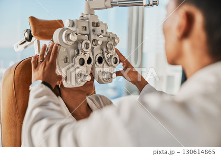 Senior optometry woman, eye exam patient and medical goal in hospital, consultation room and office with help. Elderly optician, eyesight test and phoropter for wellness, health and vision analysis 130614865