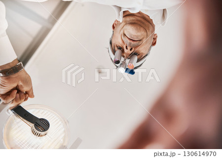 Optometry, below and a doctor with a light for a checkup, eye and vision care. Surgery, health and optometrist with equipment, lighting and tools for an exam on eyes, eyesight and optical correction 130614970