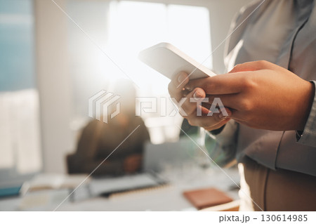 Business woman, hands typing and teamwork meeting with a female employee on a mobile app. Office, lens flare and online chat of a financial analytics worker on a cellphone reading website content Business woman, hands typing and teamwork meeting with a female employee on a mobile app. Office, lens flare and online chat of a financial analytics worker on a cellphone reading website content 130614985