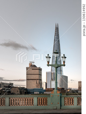 View of The Shard skyscraper with Street lamps on Bridge in front of. 130614992