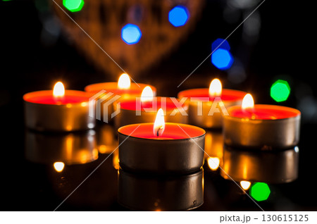 Flickering candles dance in the dark, pushing back the gloom 130615125